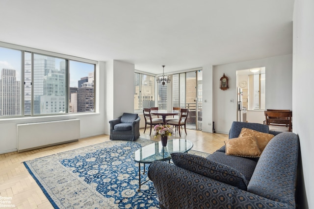 living area featuring radiator heating unit, a view of city, and a notable chandelier