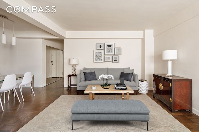 living area featuring baseboards