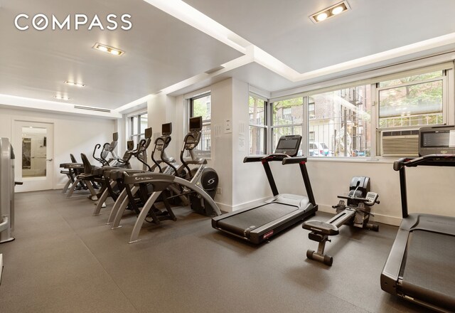 workout area featuring cooling unit and baseboards