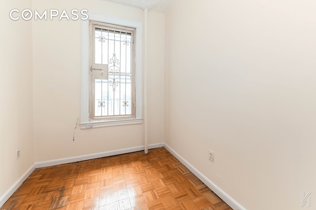 unfurnished room featuring baseboards