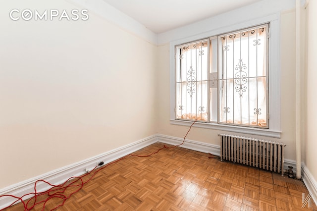 empty room with baseboards and radiator heating unit