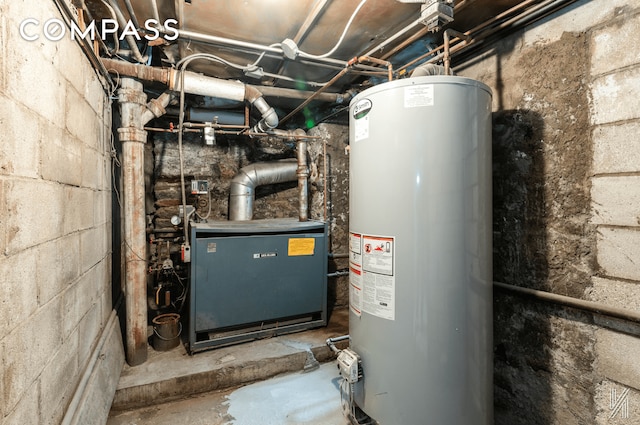 utility room featuring water heater and a heating unit