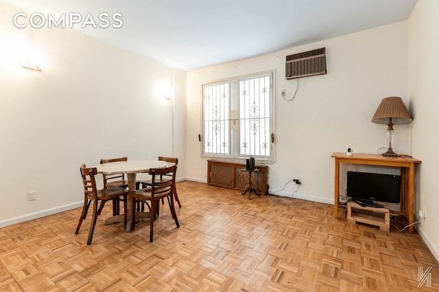 dining space with a wall mounted air conditioner and baseboards