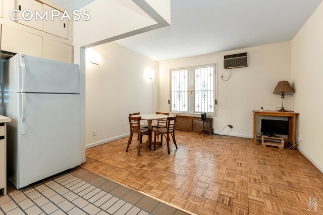 dining space featuring baseboards and a wall mounted AC