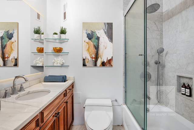 full bath with toilet, visible vents, bath / shower combo with glass door, and vanity