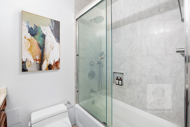 full bath featuring combined bath / shower with glass door, vanity, and toilet