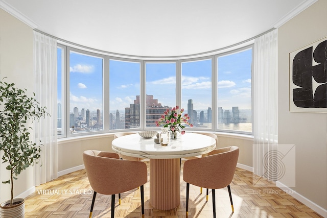 dining space with a view of city, crown molding, and baseboards