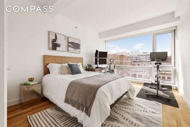 bedroom with light wood-style floors and baseboards