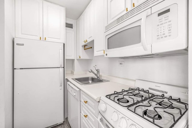 425 E 63rd St Unit W11B, New York City, NY 10065 - kitchen featuring white appliances, a sink, white cabinetry, and light countertops