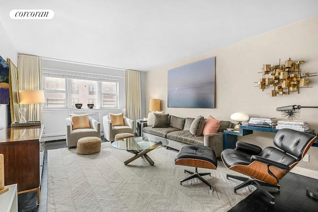 living room featuring a baseboard heating unit and visible vents