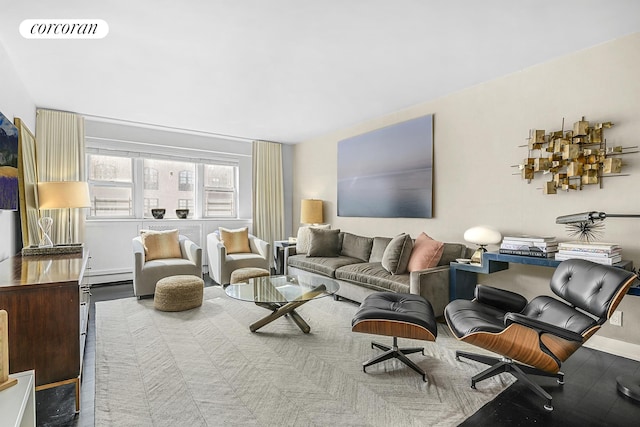 living area with a baseboard radiator, visible vents, and baseboards