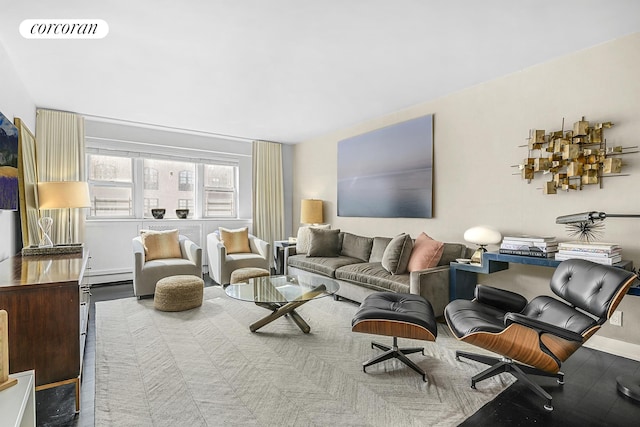 living area featuring visible vents, baseboard heating, and baseboards