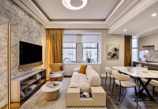 sitting room featuring baseboards, a tray ceiling, and wood finished floors