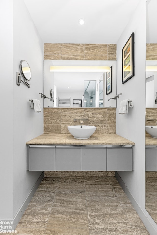 full bathroom featuring vanity, recessed lighting, and baseboards