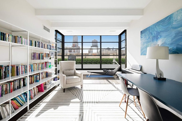 living area featuring beamed ceiling, wall of books, a wall of windows, and a city view