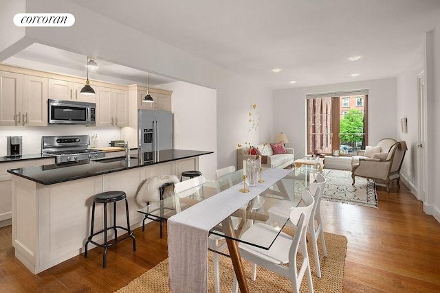 dining room featuring visible vents, baseboards, and wood finished floors