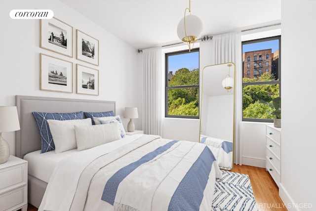 bedroom featuring light wood-style flooring and visible vents