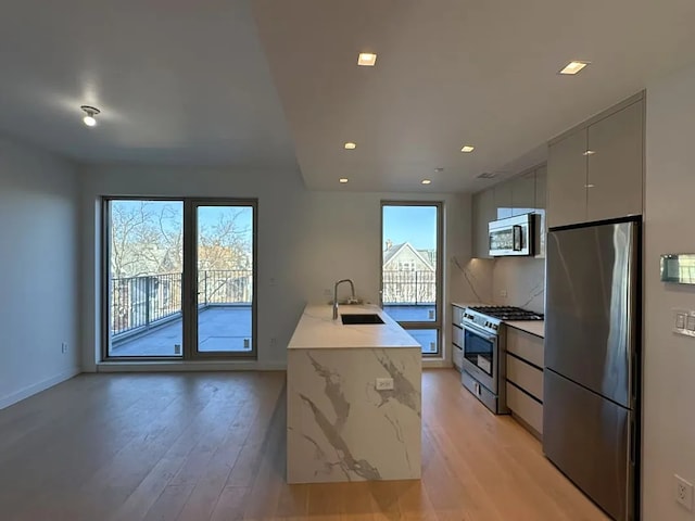 1548 72nd St Unit 302, New York City, NY 11228 - kitchen with stainless steel appliances, a sink, light wood-style flooring, modern cabinets, and recessed lighting