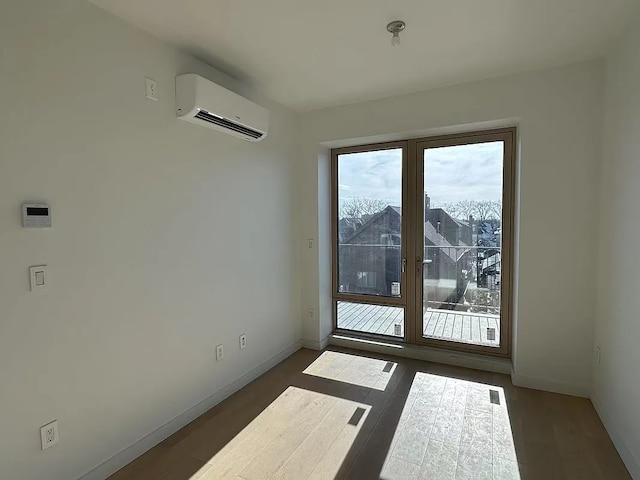 1548 72nd St Unit 302, New York City, NY 11228 - empty room with a wall mounted AC, baseboards, and wood finished floors