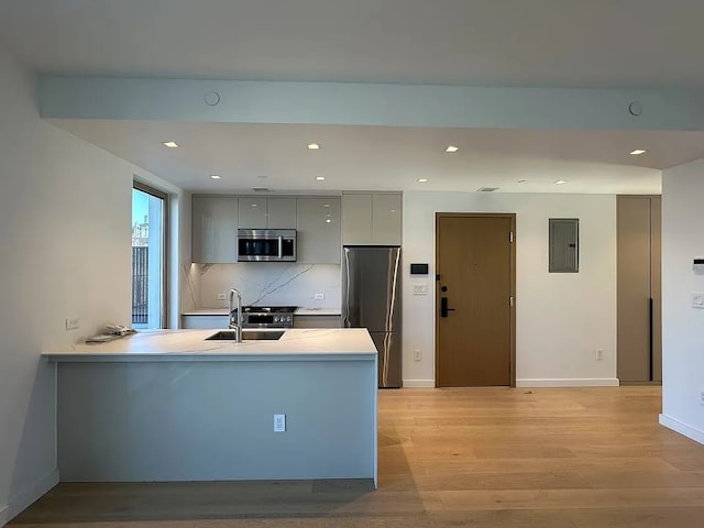 1548 72nd St Unit 302, New York City, NY 11228 - kitchen featuring appliances with stainless steel finishes, a sink, modern cabinets, gray cabinets, and a peninsula