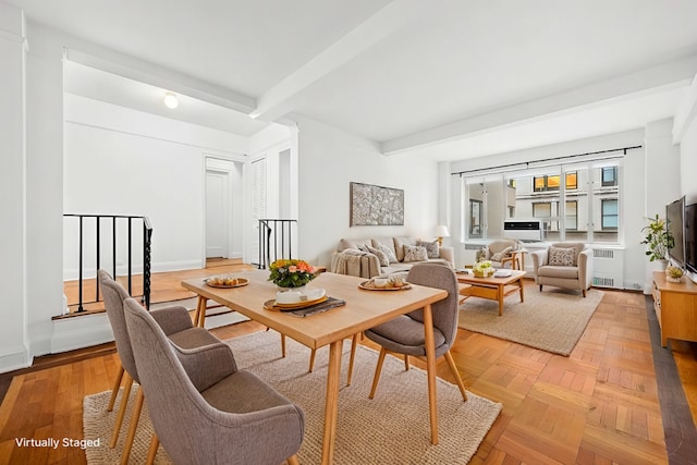 dining area featuring radiator, beamed ceiling, and baseboards