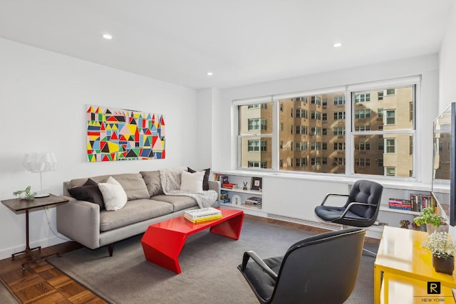 living area featuring baseboards, plenty of natural light, and recessed lighting