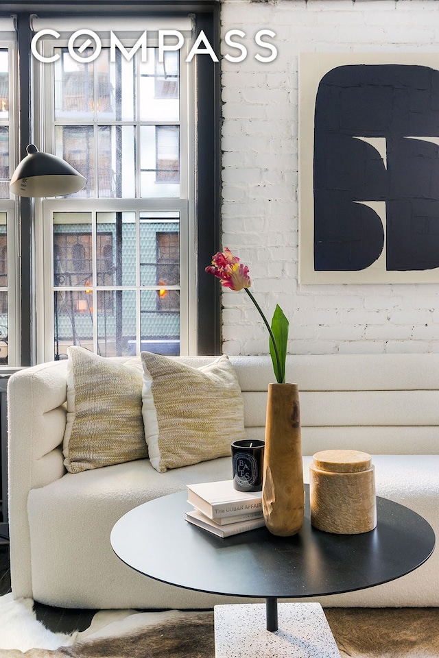 interior space featuring brick wall