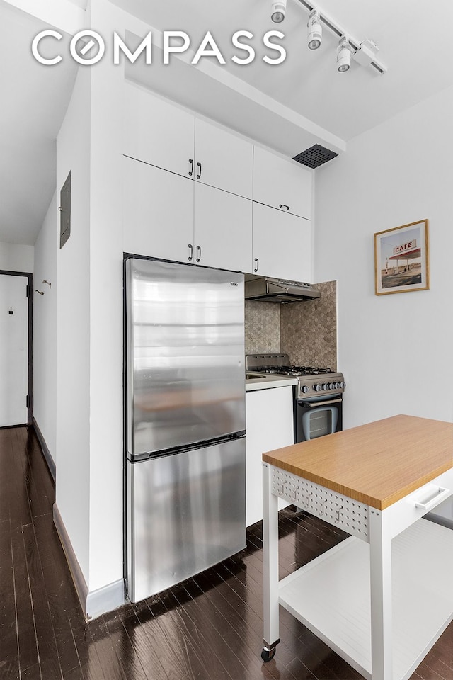 kitchen featuring white cabinetry, tasteful backsplash, dark wood-style floors, range with gas cooktop, and stainless steel fridge