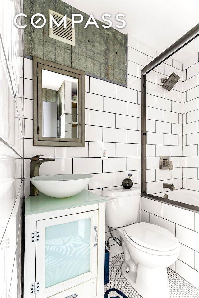 57 Thompson St Unit 2B, New York City, NY 10012 - full bathroom with tile walls, vanity, tile patterned flooring, and shower / bathtub combination