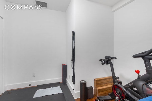 exercise area with baseboards and visible vents