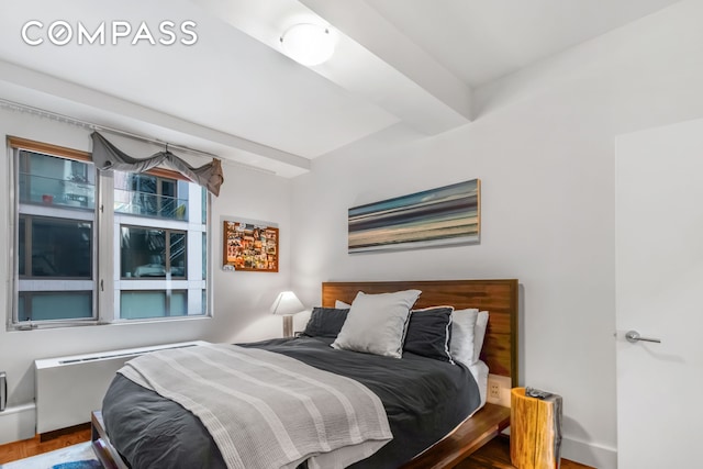 bedroom with wood finished floors and baseboards