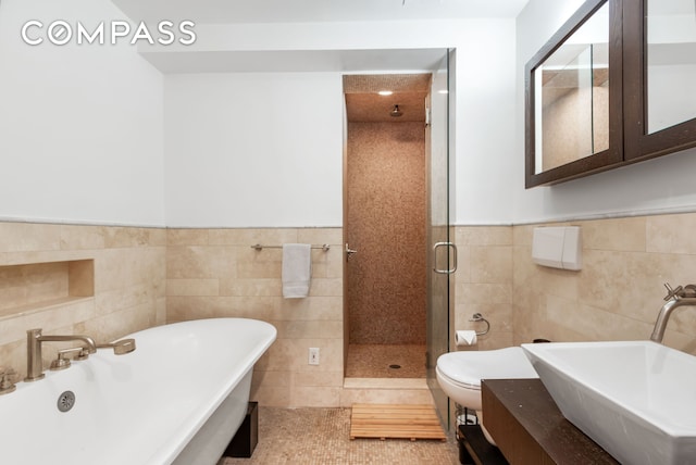 bathroom featuring a stall shower, tile patterned flooring, tile walls, and a soaking tub