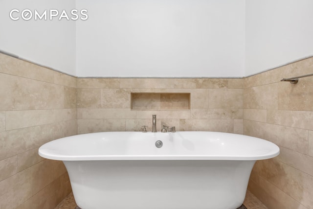 116 W 22nd St Unit 3, New York City, NY 10011 - full bathroom with tile walls and a freestanding bath