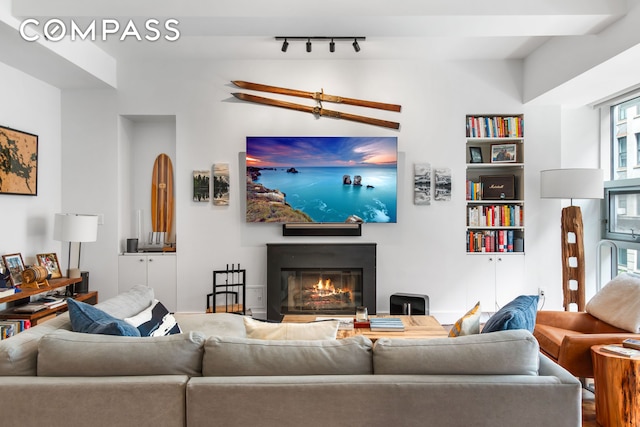 116 W 22nd St Unit 3, New York City, NY 10011 - living room featuring a glass covered fireplace and track lighting