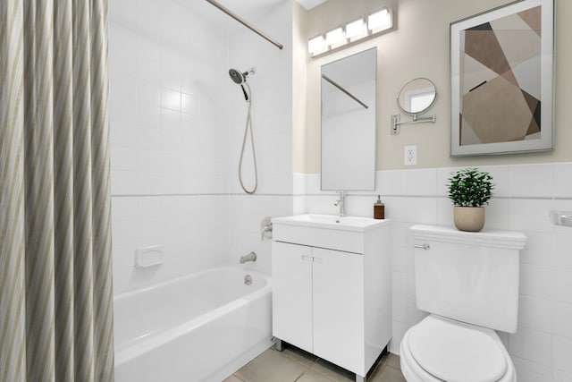 full bath featuring vanity, shower / tub combo with curtain, toilet, tile patterned floors, and a wainscoted wall