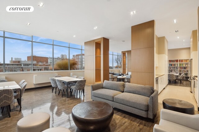 living room featuring dark wood finished floors, a glass covered fireplace, and visible vents