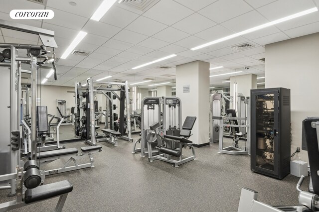 workout area featuring a paneled ceiling and visible vents