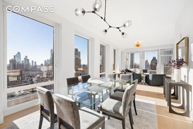 dining room with a view of city and a notable chandelier