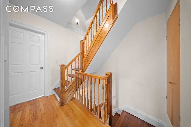 stairs featuring baseboards and wood finished floors