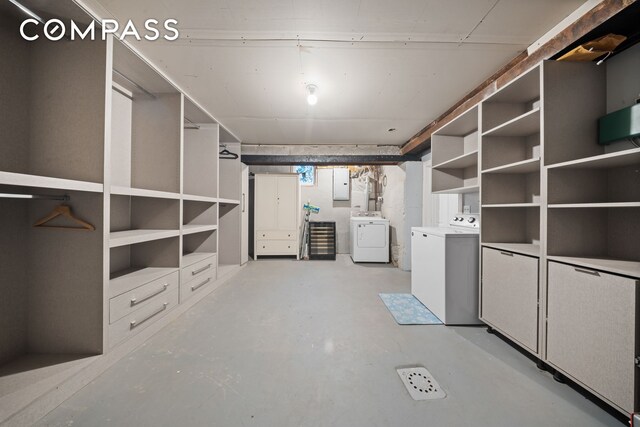 unfinished basement with electric panel and washer and clothes dryer