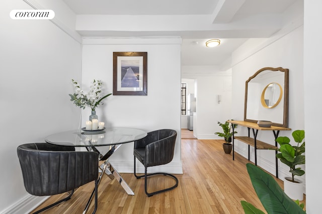 dining room featuring baseboards, visible vents, and light wood-style floors