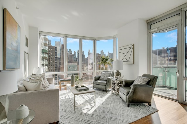 sunroom / solarium with visible vents, a wealth of natural light, and a city view