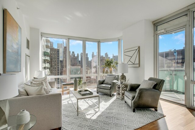 interior space featuring a healthy amount of sunlight, visible vents, and a city view