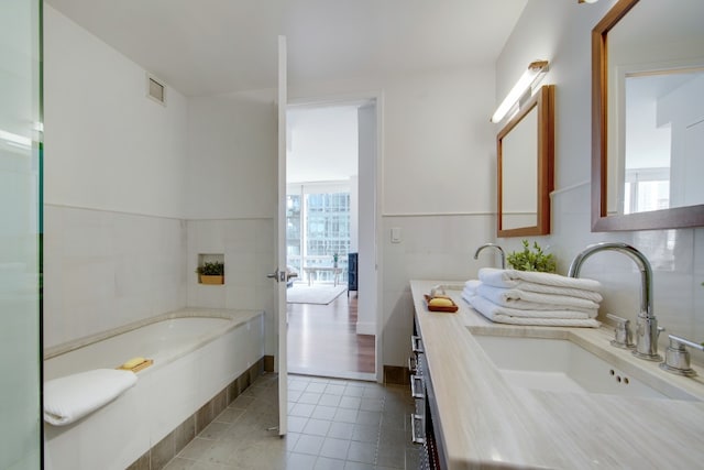 full bathroom with a bath, vanity, visible vents, and tile patterned floors