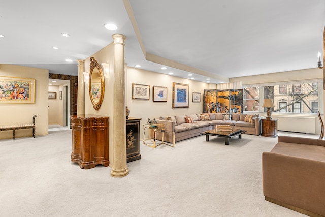 carpeted living room with decorative columns and recessed lighting