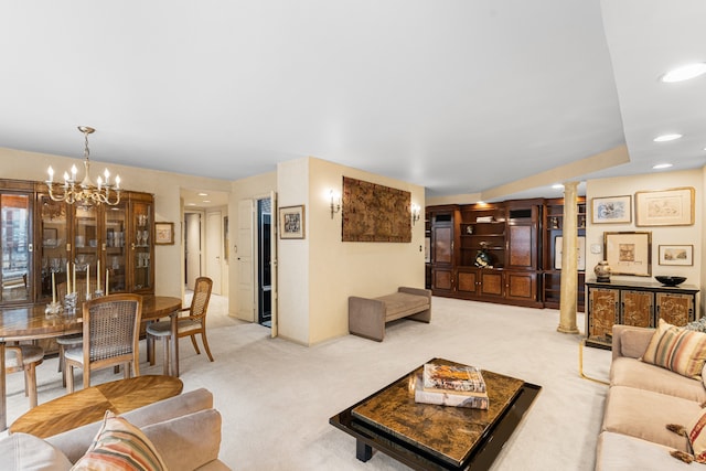 carpeted living room with a notable chandelier, recessed lighting, baseboards, and decorative columns