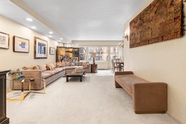 carpeted living area with an inviting chandelier, baseboards, and recessed lighting