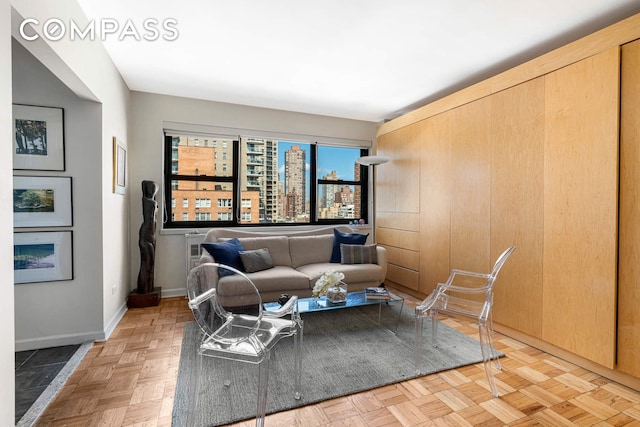 305 E 72nd St Unit 13I, New York City, NY 10021 - living room featuring baseboards