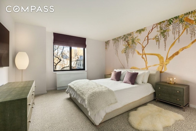 bedroom featuring light carpet and baseboards