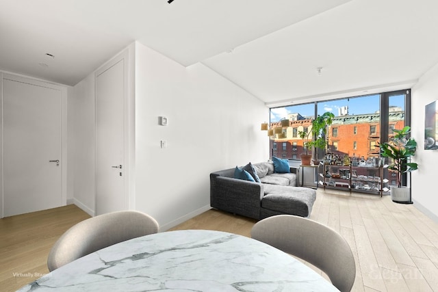 living room featuring light wood-style flooring and baseboards